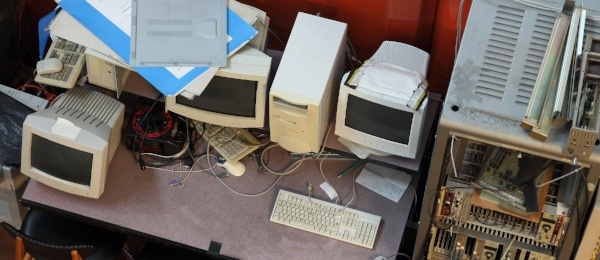 Old computer monitors, keyboards, mouses, motherboards - and other computer parts - in a junkyard.