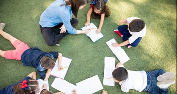 students working in a group together with their teachers
