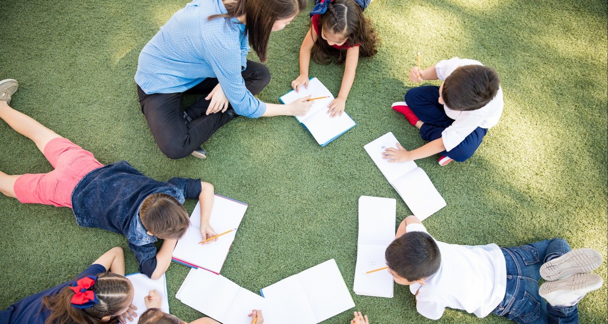 students working in a group together with their teachers